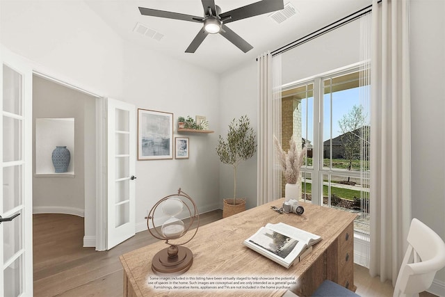 office space with french doors, visible vents, a ceiling fan, and wood finished floors