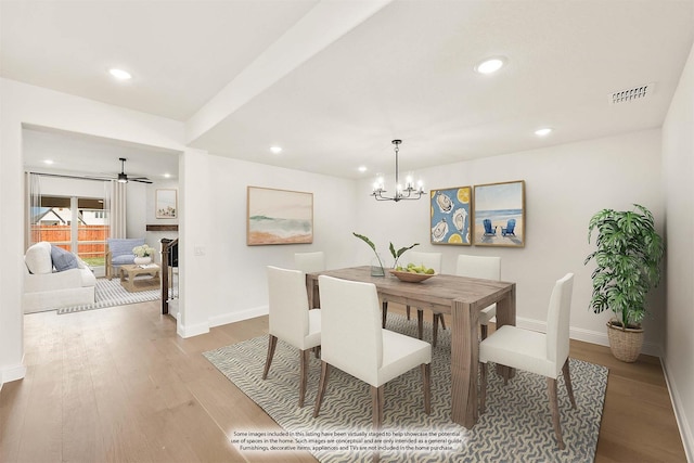 dining area with visible vents, baseboards, and wood finished floors