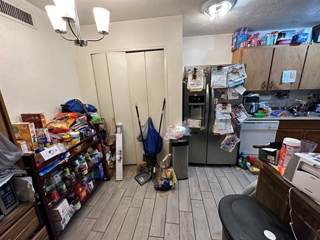 interior space with sink, dishwasher, a notable chandelier, light hardwood / wood-style flooring, and refrigerator with ice dispenser