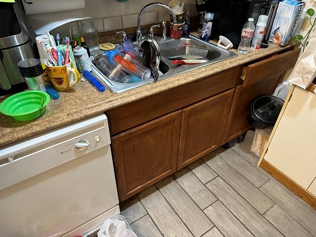 kitchen featuring dishwasher and light wood-type flooring