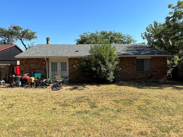 back of house featuring french doors and a yard