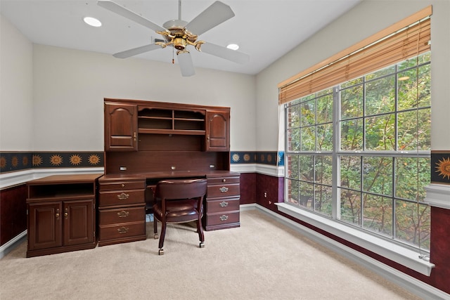 home office with ceiling fan and light colored carpet