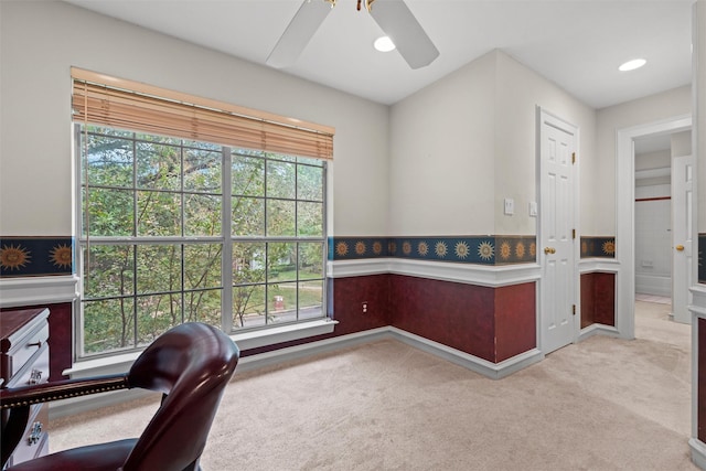 home office with ceiling fan and light carpet