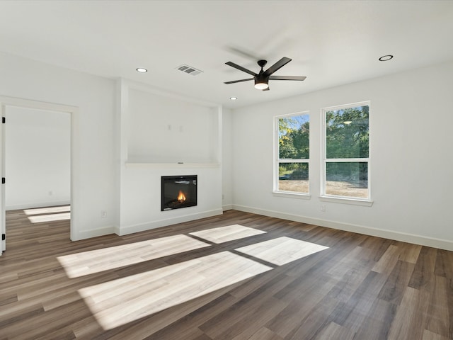 unfurnished living room featuring hardwood / wood-style flooring and ceiling fan