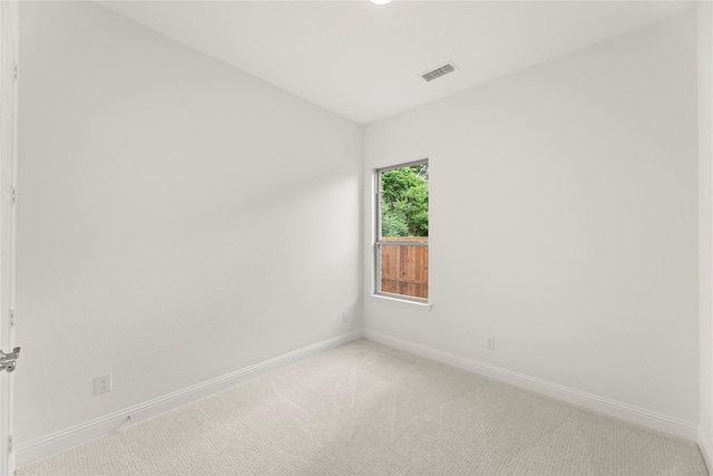 unfurnished room featuring light colored carpet, baseboards, and visible vents