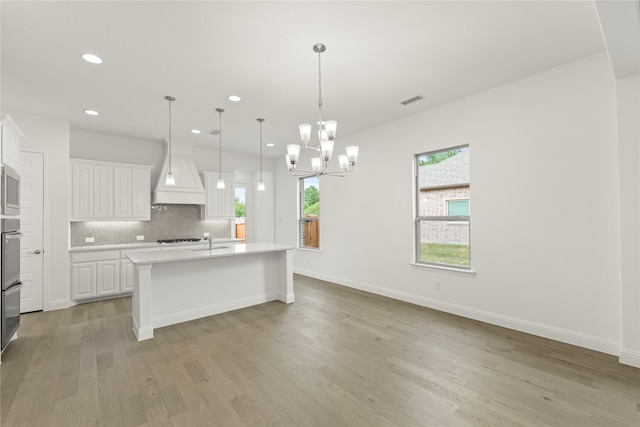 3601 Long Branch Blvd, Rowlett, TX 75088 - kitchen featuring custom range hood, light countertops, healthy amount of natural light, light wood-style floors, and recessed lighting