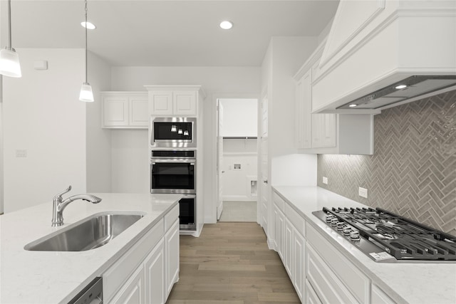 3601 Long Branch Blvd, Rowlett, TX 75088 - kitchen with a sink, appliances with stainless steel finishes, premium range hood, white cabinetry, and recessed lighting