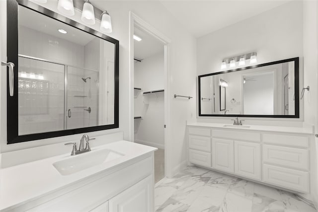 3601 Long Branch Blvd, Rowlett, TX 75088 - bathroom featuring a stall shower, marble look tile flooring, two vanities, a spacious closet, and baseboards
