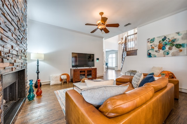 living room with crown molding, wood-type flooring, a fireplace, and ceiling fan