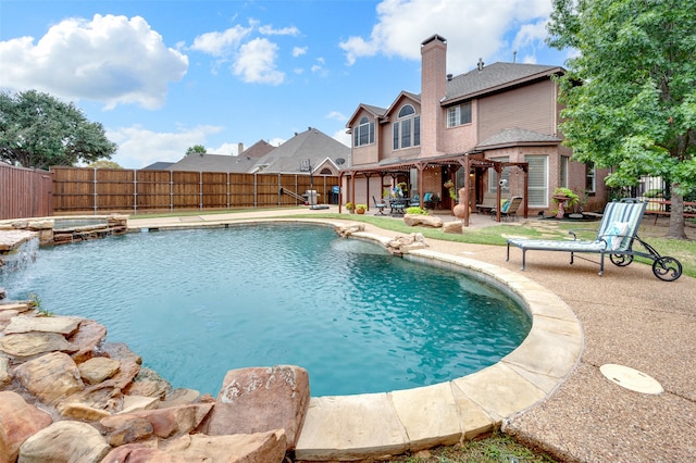 view of pool featuring a patio area and an in ground hot tub