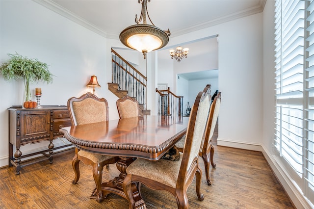 dining space featuring a notable chandelier, hardwood / wood-style flooring, ornamental molding, and plenty of natural light