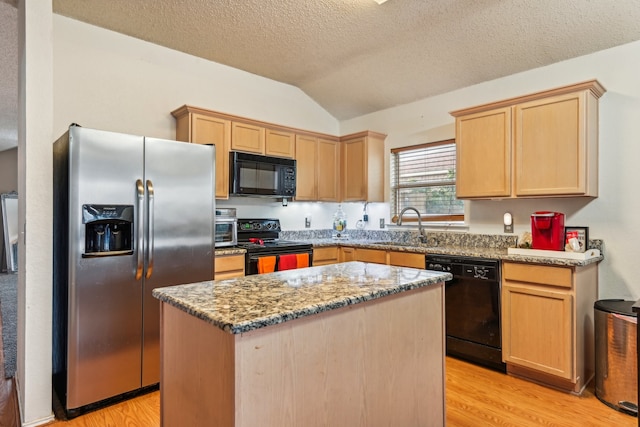 kitchen featuring a kitchen island, light stone countertops, vaulted ceiling, light hardwood / wood-style flooring, and black appliances