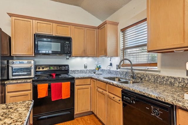 kitchen with sink, black appliances, vaulted ceiling, light stone counters, and a textured ceiling