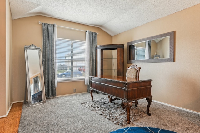 office featuring lofted ceiling, hardwood / wood-style floors, and a textured ceiling