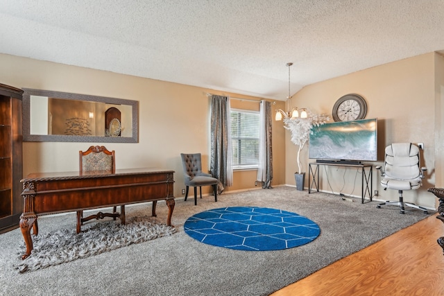 sitting room with vaulted ceiling, hardwood / wood-style flooring, a textured ceiling, and an inviting chandelier