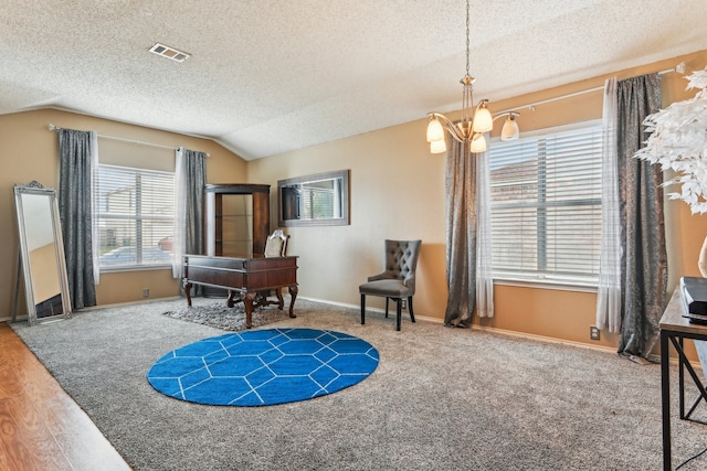 sitting room featuring a textured ceiling, vaulted ceiling, a notable chandelier, and wood-type flooring