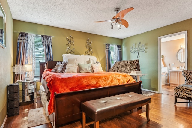 bedroom featuring a textured ceiling, wood-type flooring, and ceiling fan