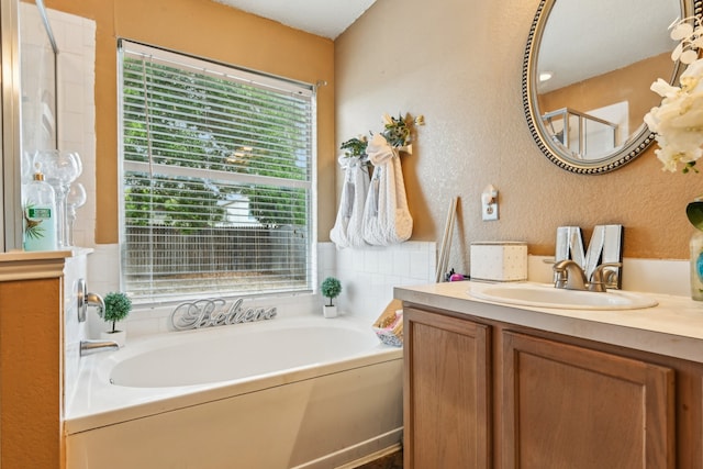 bathroom featuring a bath and vanity