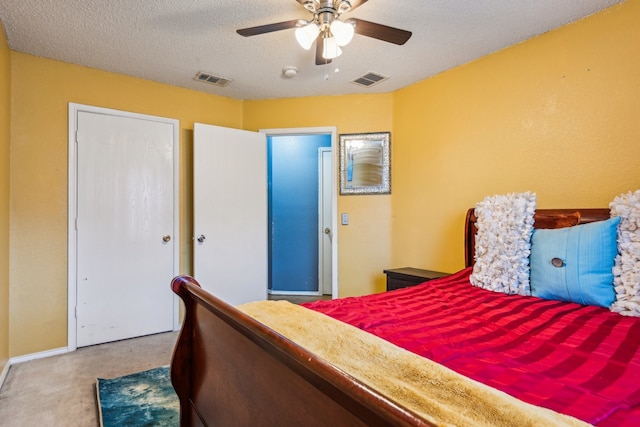 bedroom featuring a textured ceiling, carpet flooring, and ceiling fan