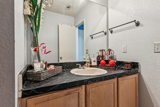 bathroom featuring vanity and a textured ceiling