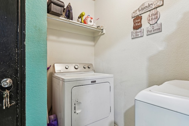 washroom featuring washer and dryer