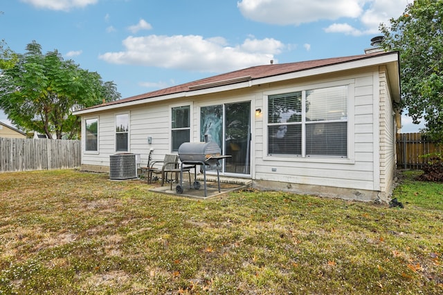 rear view of property with a patio, a lawn, and central air condition unit