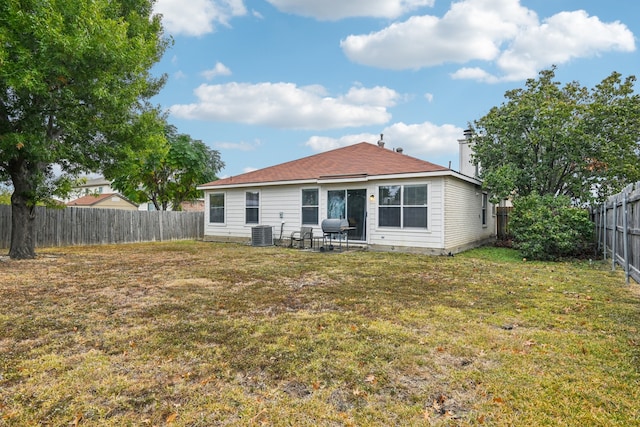 rear view of property with a yard, a patio, and cooling unit