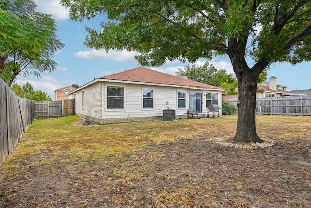 back of property featuring a lawn