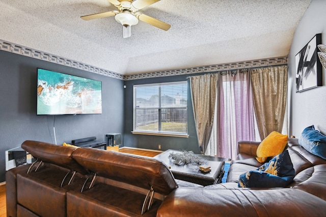 cinema featuring a textured ceiling, hardwood / wood-style flooring, and ceiling fan