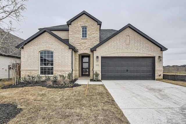 french country style house with a garage