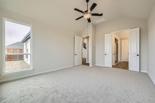 unfurnished bedroom with vaulted ceiling, ceiling fan, and carpet flooring