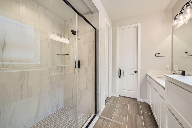 bathroom featuring vanity and a shower with shower door