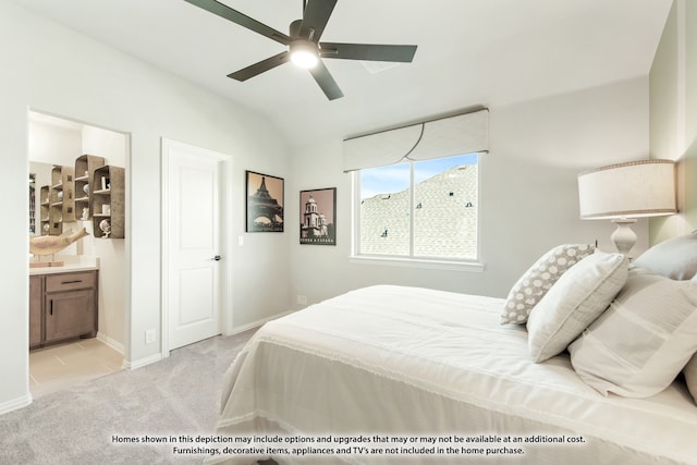 bedroom featuring lofted ceiling, ensuite bathroom, light colored carpet, and ceiling fan