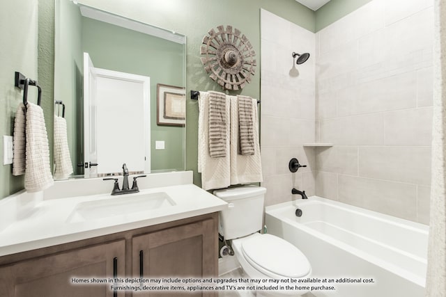 full bathroom with vanity, toilet, and tiled shower / bath