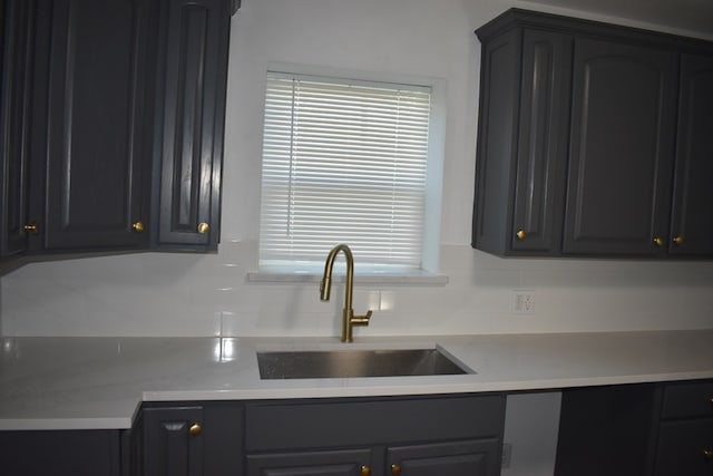 kitchen with light stone countertops and sink