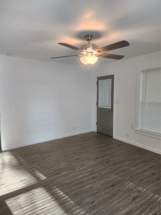 spare room with ceiling fan and dark hardwood / wood-style floors