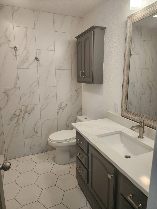 bathroom featuring vanity, toilet, and tile patterned flooring