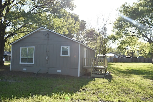 view of side of property with a lawn