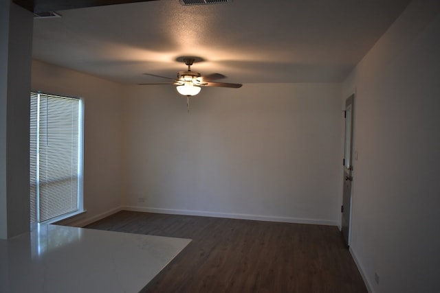 unfurnished room with ceiling fan and dark hardwood / wood-style floors