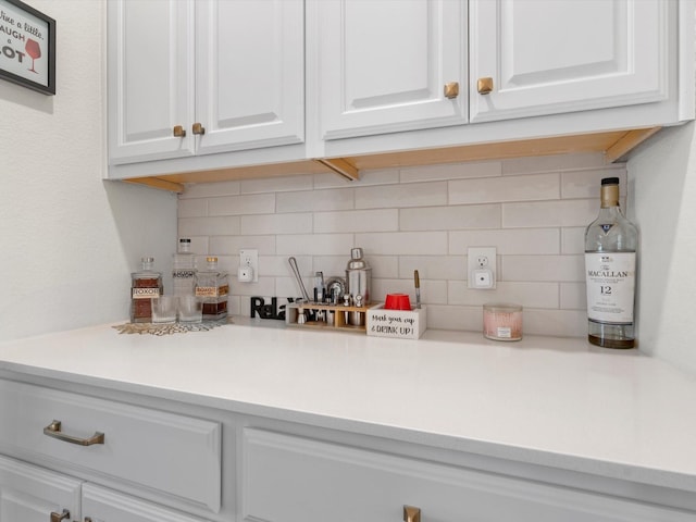 kitchen with white cabinetry and decorative backsplash