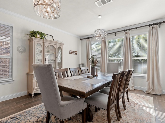 dining room with an inviting chandelier and ornamental molding