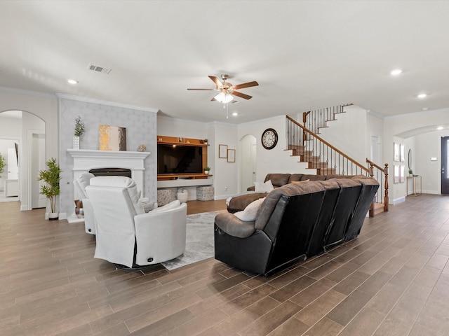 living room featuring ceiling fan, ornamental molding, and hardwood / wood-style floors