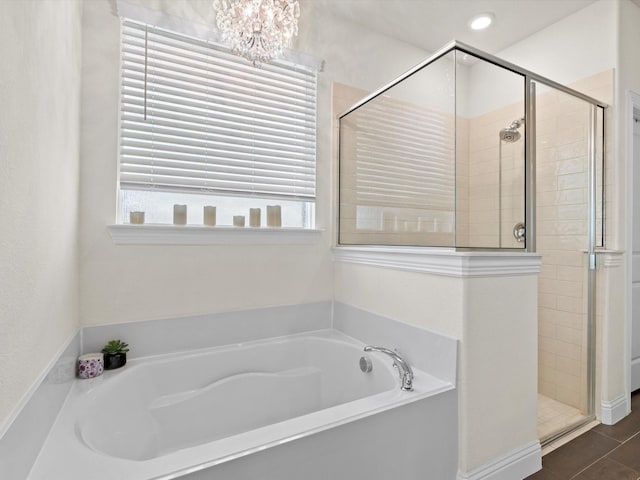 bathroom featuring an inviting chandelier, tile patterned floors, a healthy amount of sunlight, and shower with separate bathtub