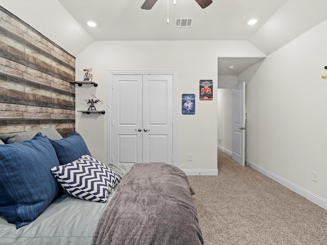 carpeted bedroom featuring lofted ceiling, ceiling fan, and a closet