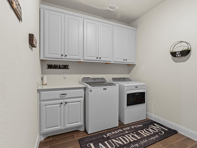 laundry area with cabinets and washer and clothes dryer