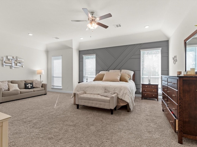 bedroom with multiple windows, vaulted ceiling, light colored carpet, and ceiling fan