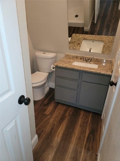 bathroom featuring vanity, toilet, and hardwood / wood-style flooring