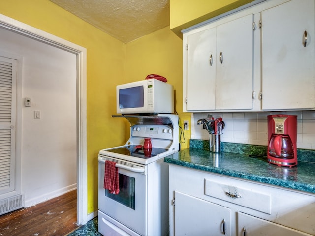 kitchen featuring backsplash, white cabinets, white appliances, and dark hardwood / wood-style flooring