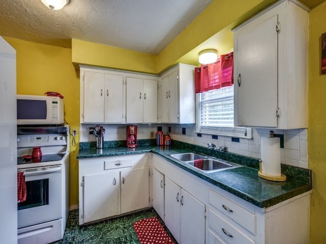 kitchen featuring decorative backsplash, white cabinetry, sink, and white appliances