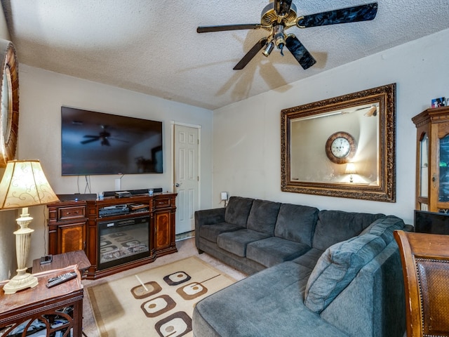 living room featuring a textured ceiling and ceiling fan